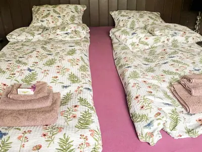 two twin beds with blankets and towels on them at 6 person holiday home in Aure-By Traum in Aure