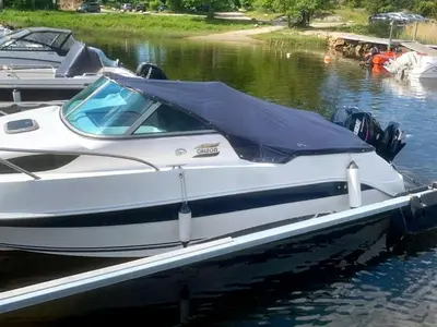 a white boat tied to a dock in the water at 6 person holiday home in Aure-By Traum in Aure