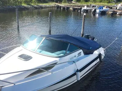 a white boat is docked in the water at 6 person holiday home in Aure-By Traum in Aure