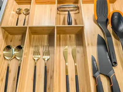 a wooden drawer with utensils on a wooden table at ÅNDALSNES UNDERGROUND flat in Åndalsnes