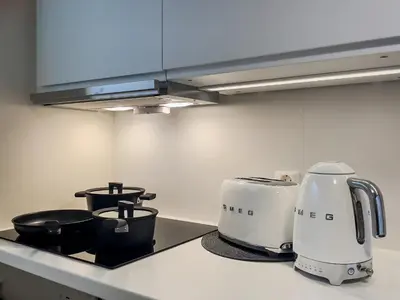 a kitchen counter with two toaster and pots on it at ÅNDALSNES UNDERGROUND flat in Åndalsnes