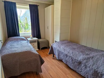 a bedroom with two beds and a window at Otnes Fjordside - Large 80m2 860sqft in Aurland