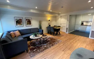 a living room with a couch and a table at Otnes Fjordside - Large 80m2 860sqft in Aurland