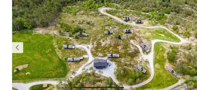 an aerial view of a campground with cars and a road at Lem Cabins in Sogndal