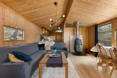 a living room with a couch and a table at Lem Cabins in Sogndal