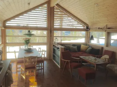 a living room with a couch and a table at Skarehaug - koselig hytte med 3 soverom in Eggedal
