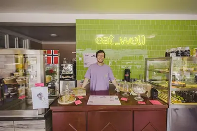 a man standing behind a counter in a kitchen at Tiglkåk in Åndalsnes