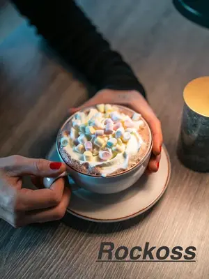 a person holding a bowl of ice cream with marshmallows at Private apartments!Oppdal Alpintun, Skisenter-Stølen in Oppdal