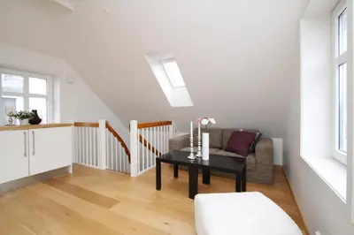 a living room with a table and a chair at Villa Skansen in Bergen