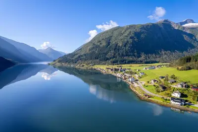 arial view of a lake with mountains in the background at Cabin alongside the beautiful fjærlandsfjord in Fjarland
