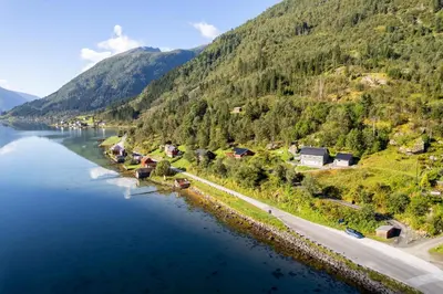 an aerial view of a river with a mountain at Cabin alongside the beautiful fjærlandsfjord in Fjarland