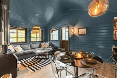 a living room with a couch and a table at Cabin alongside the beautiful fjærlandsfjord in Fjarland