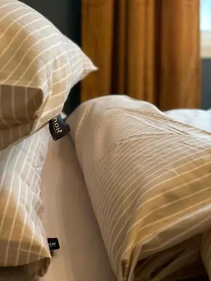 a bed with two pillows on top of it at City Center Apartment in Ålesund