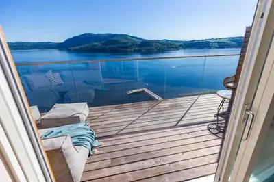 a balcony with a view of a body of water at Mjøssuite with lovely view in Ringsaker