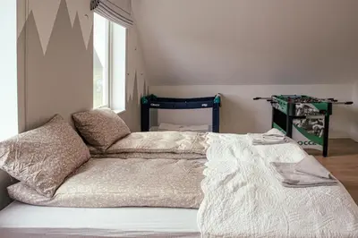 a bedroom with a bed and a window at Feriehus med badestamp in Lavik