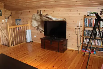 a living room with a flat screen tv on a wall at Storemyr by Norgesbooking - cabin with amazing view in Hol