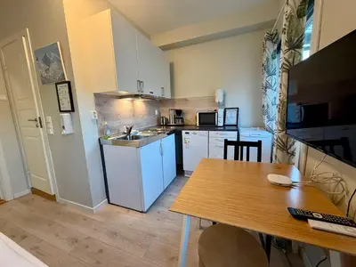 a small kitchen with a table and a counter top at Åndalsnes Sentrum 1-room Apartment in Åndalsnes