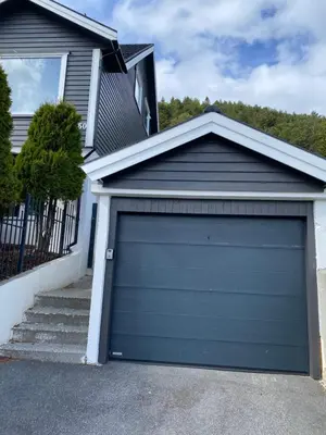 a garage door in front of a house at Sukkertoppen Apartment in Ålesund