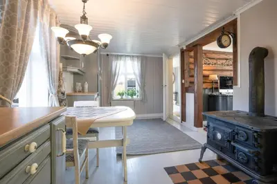 a kitchen with a table and a stove in a room at Eika Cottage: Cozy, rural, spacious and well-equiped in Åmot