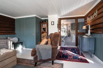 a living room with a couch and a chair at Eika Cottage: Cozy, rural, spacious and well-equiped in Åmot