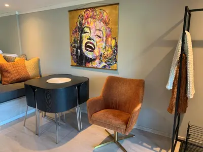 a room with a table and a chair and a painting at Olden Studioapartment in Olden