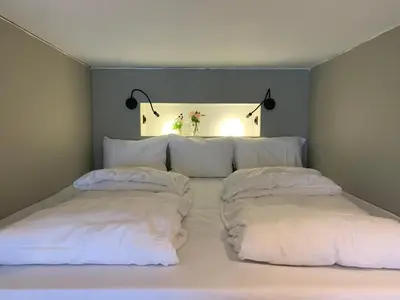 a bedroom with two white pillows on a bed at Olden Studioapartment in Olden