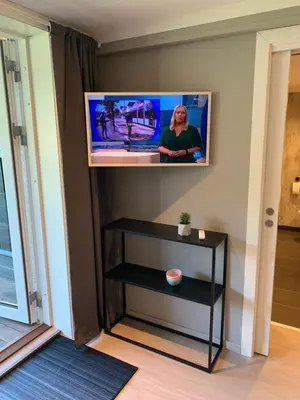 a flat screen tv on a wall above a table at Olden Studioapartment in Olden