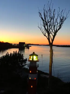 a lantern sitting on top of a lighthouse on a body of water at Atlantic Panorama in Vevang