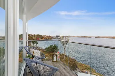 a balcony of a house with a view of the water at Atlantic Panorama in Vevang