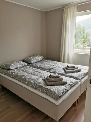 a bedroom with a bed with towels on it at Nature View Apartment in Espeland in Bergen