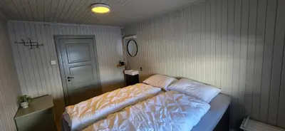a bedroom with a bed and a door and a door at Røisheim in Tyinkrysset