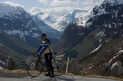 a man riding a bike on a mountain road at Hotel Videseter in Stryn