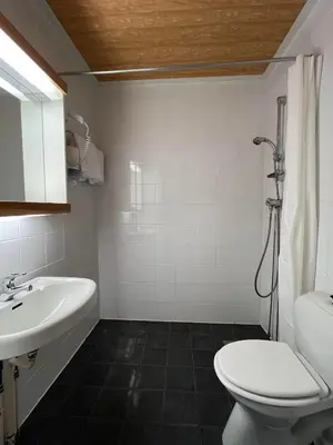 a bathroom with a toilet and a sink at Hotel Videseter in Stryn