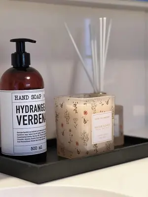 a bottle of hand soap and a box on a shelf at Indreli feriehus in Flåm