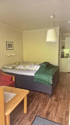 a small bedroom with a bed and a table at Kvamsdal Pensjonat 2 in Eidfjord