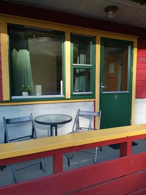 a table and two chairs sitting outside of a restaurant at Kvamsdal Pensjonat 2 in Eidfjord