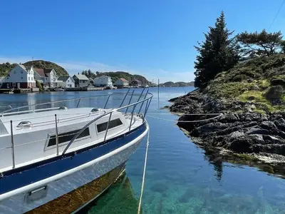 a boat is docked in a body of water at 6 person holiday home in Espevær-By Traum in Espevær