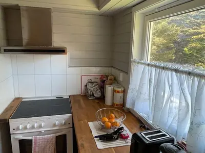 a kitchen with a stove and a window at 6 person holiday home in Espevær-By Traum in Espevær