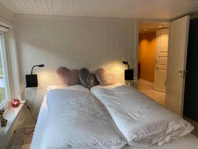 a bedroom with two beds with white sheets at Rødseth gårdsovernatting Dobbeltrom in Molde