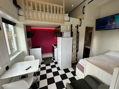 a small room with a bed and a desk at Rødseth gårdsovernatting Dobbeltrom in Molde