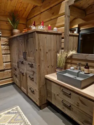 a kitchen with a sink in a wooden cabin at Liaplassen Timber Lodge in Beitostøl