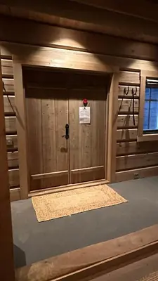 a room with a wooden door with a window at Liaplassen Timber Lodge in Beitostøl