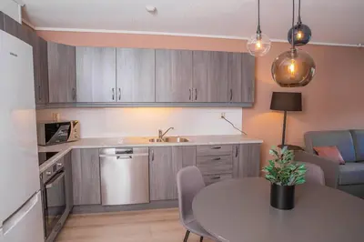 a kitchen with a table and a dining room at Vestly in Etnesjøen