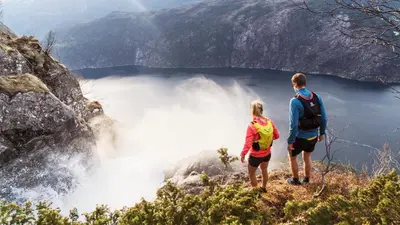 a man and a woman standing on top of a mountain at Langfoss in Etnesjøen