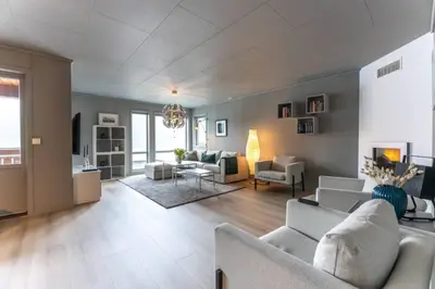 a large living room with couches and a living room with at Langfoss in Etnesjøen