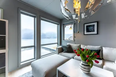 a living room with a couch and a chandelier at Langfoss in Etnesjøen