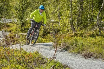 a man riding a bike on a trail at Fosskamben 1 Moderne hytte ikkje langt frå Sogndal in Sogndal