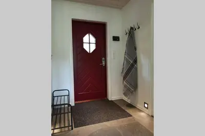 a red door with a window in a hallway at Casa Kleiv i Sogndalsdalen in Sogndal
