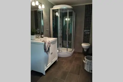 a bathroom with a sink and a shower and a toilet at Casa Kleiv i Sogndalsdalen in Sogndal