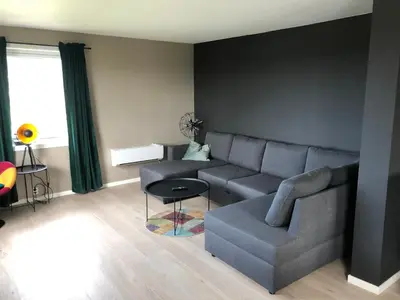 a living room with a couch and a table at Atlantic Panorama Villa Kalle in Kristiansund